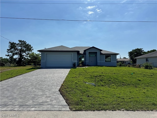 view of front facade with a garage and a front lawn