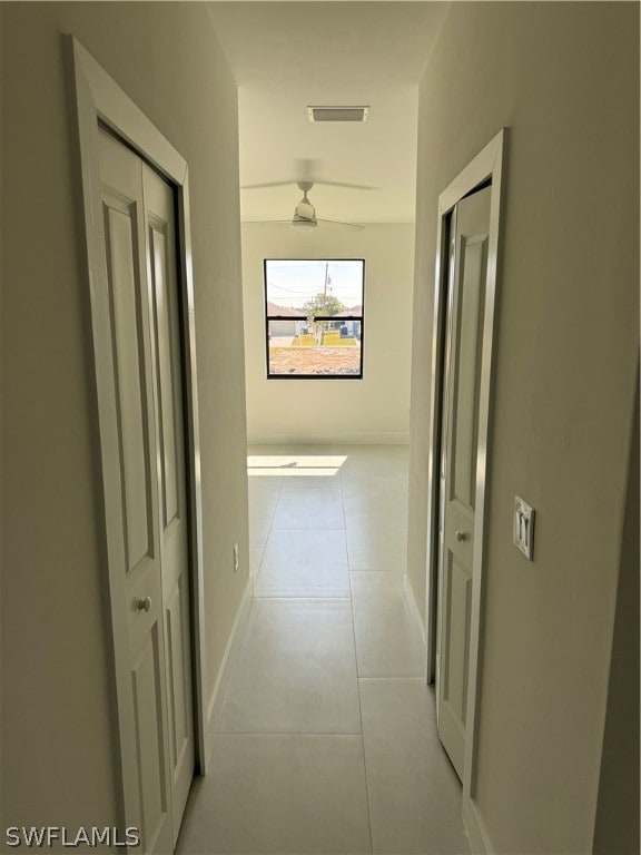 corridor with light tile floors