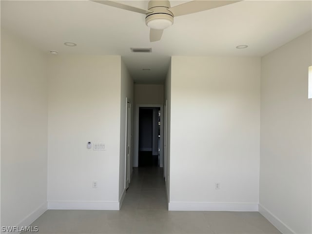 unfurnished room with tile flooring and ceiling fan