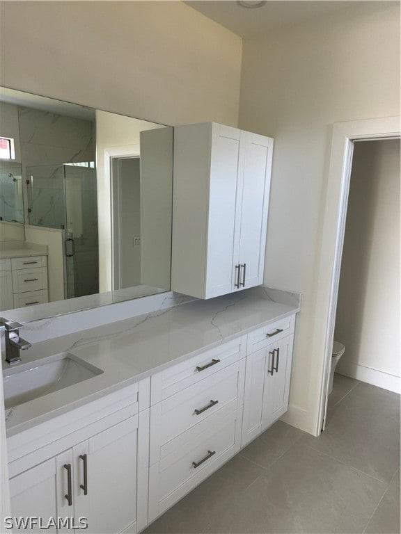 bathroom featuring tile flooring, vanity, an enclosed shower, and toilet