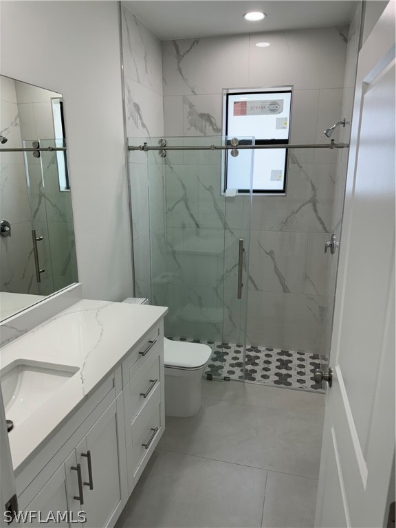 bathroom with walk in shower, vanity, toilet, and tile flooring