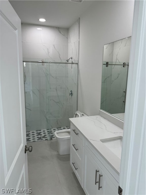 bathroom with an enclosed shower, toilet, tile floors, and vanity