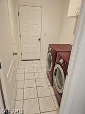 washroom with light tile floors and washer and clothes dryer