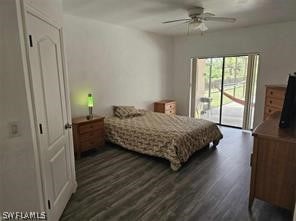 bedroom featuring dark hardwood / wood-style floors, ceiling fan, and access to exterior