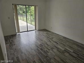 unfurnished room featuring dark hardwood / wood-style flooring