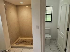 bathroom with toilet and tile flooring