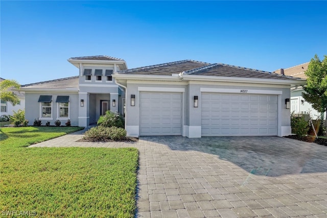 view of front of property with a front lawn and a garage