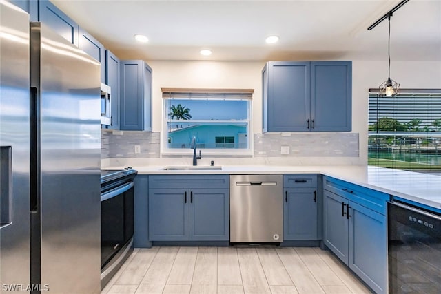 kitchen with light hardwood / wood-style flooring, tasteful backsplash, sink, and black appliances