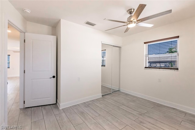 unfurnished bedroom with a closet, ceiling fan, and light hardwood / wood-style floors