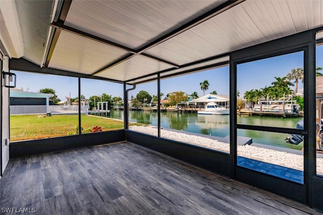 unfurnished sunroom with a water view