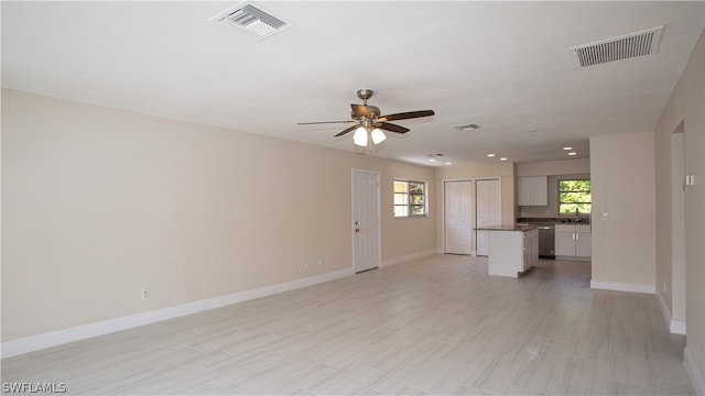 tiled empty room with ceiling fan