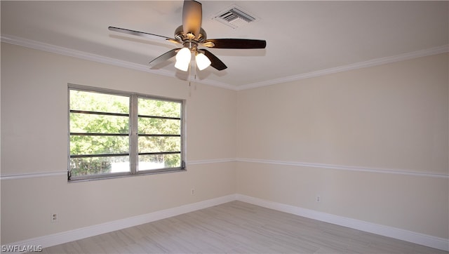 empty room with ornamental molding, ceiling fan, and hardwood / wood-style flooring