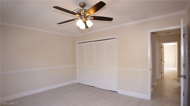 unfurnished bedroom with a closet, ceiling fan, and crown molding