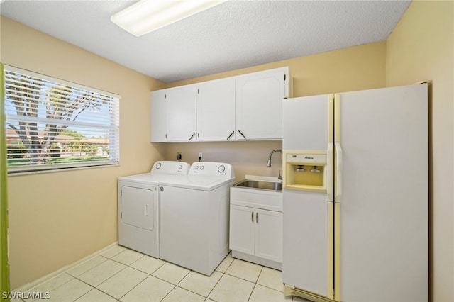 laundry area with cabinets, hookup for an electric dryer, independent washer and dryer, sink, and light tile flooring