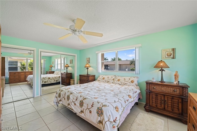 bedroom featuring light tile floors, ceiling fan, and a textured ceiling