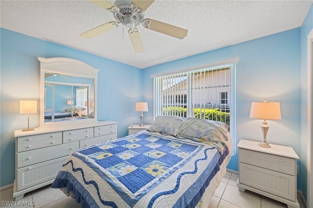 bedroom with a textured ceiling, light tile flooring, and ceiling fan