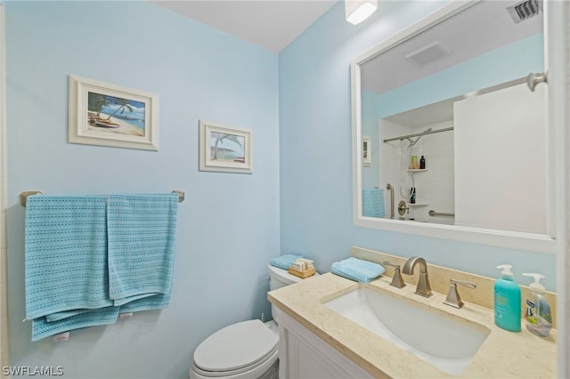 full bathroom featuring tiled shower / bath, toilet, and vanity