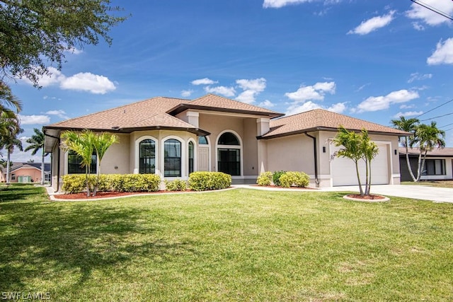 mediterranean / spanish-style home featuring a front yard and a garage