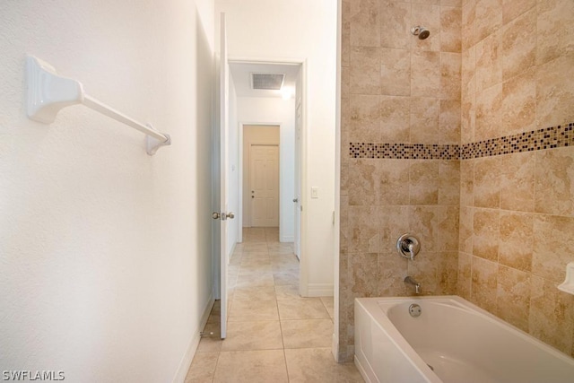 bathroom featuring tile patterned floors and tiled shower / bath