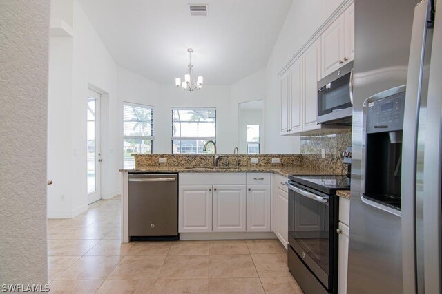 kitchen with kitchen peninsula, white cabinets, and appliances with stainless steel finishes