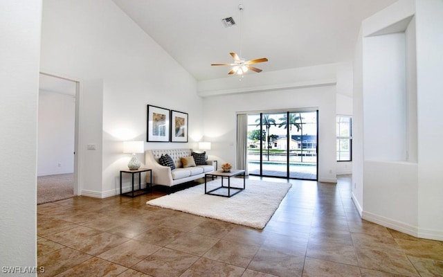 living room with ceiling fan and high vaulted ceiling