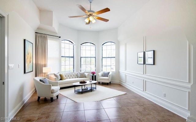 tiled living room featuring ceiling fan