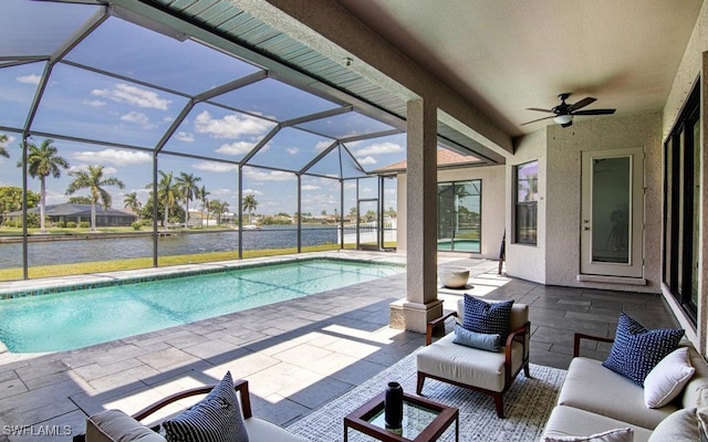 view of swimming pool featuring an outdoor living space, ceiling fan, a water view, glass enclosure, and a patio