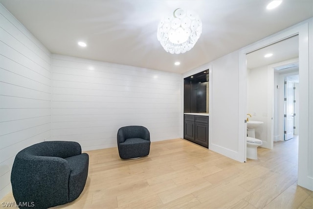 living area featuring a chandelier and light wood-type flooring