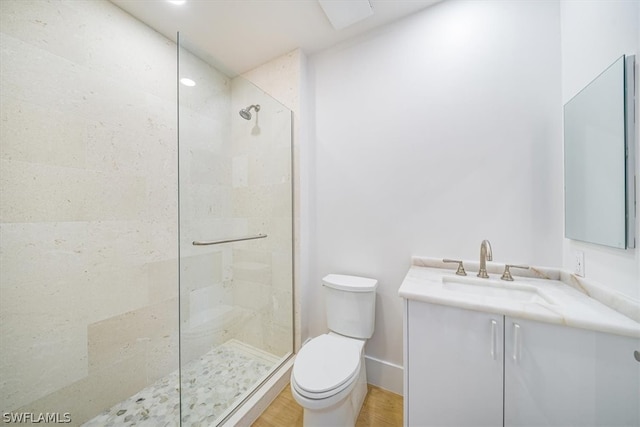 bathroom featuring hardwood / wood-style flooring, an enclosed shower, toilet, and large vanity