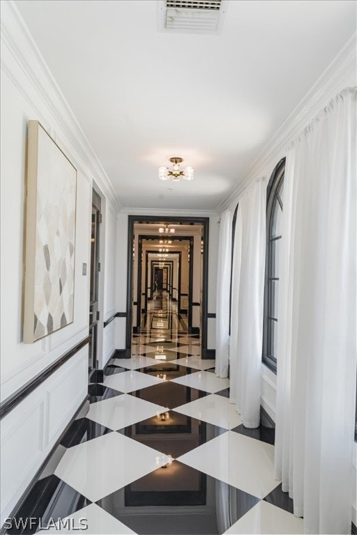 corridor featuring tile flooring and ornamental molding