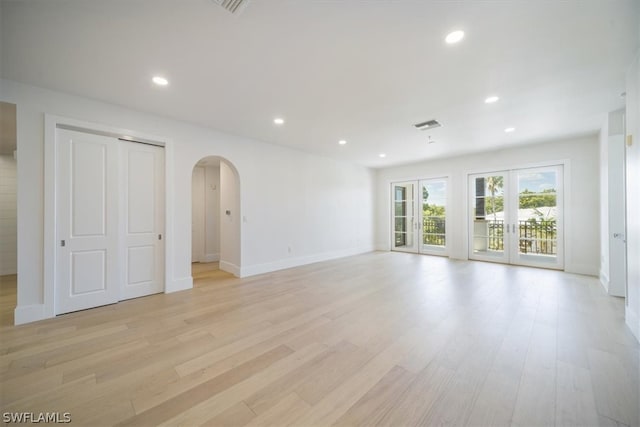 unfurnished room featuring light hardwood / wood-style flooring and french doors