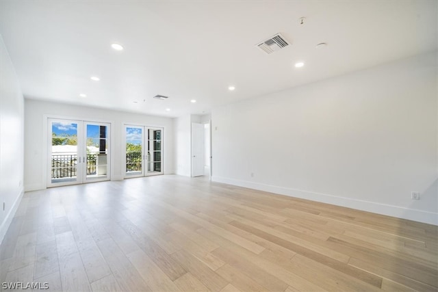 unfurnished room with light hardwood / wood-style flooring and french doors