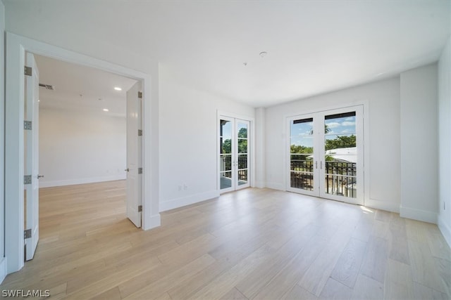 unfurnished room with light hardwood / wood-style floors and french doors