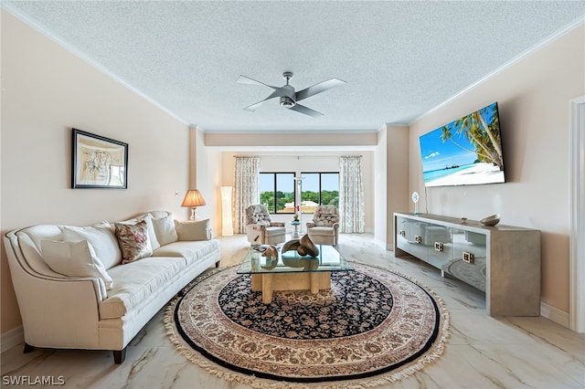 living room featuring ceiling fan, a textured ceiling, and ornamental molding