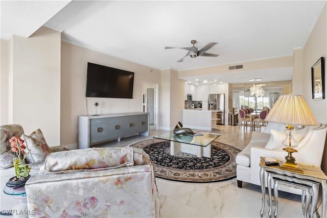 living room with ceiling fan and ornamental molding