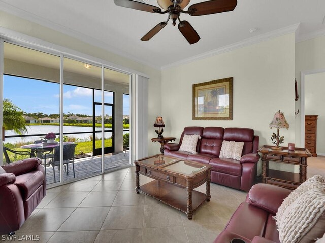 tiled living room with ceiling fan, a water view, and crown molding