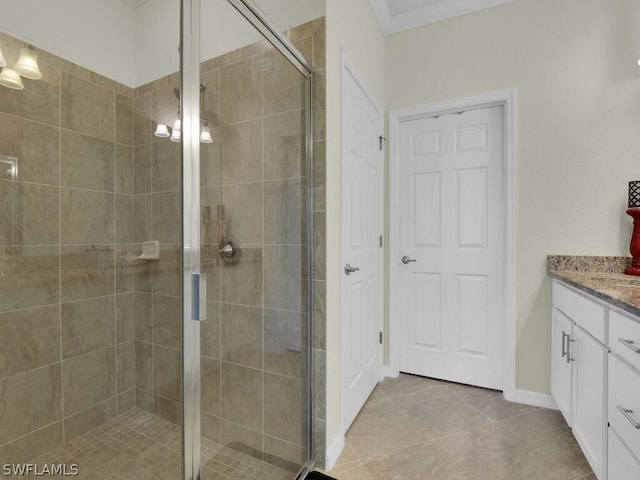 bathroom featuring walk in shower, vanity, and tile patterned flooring