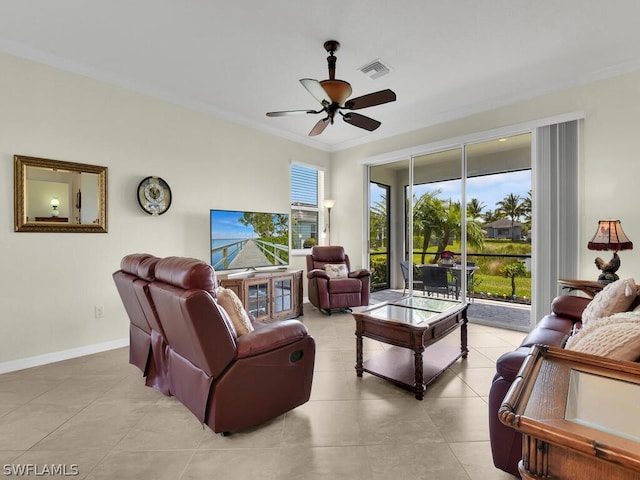 living room with light tile patterned floors, ornamental molding, and ceiling fan