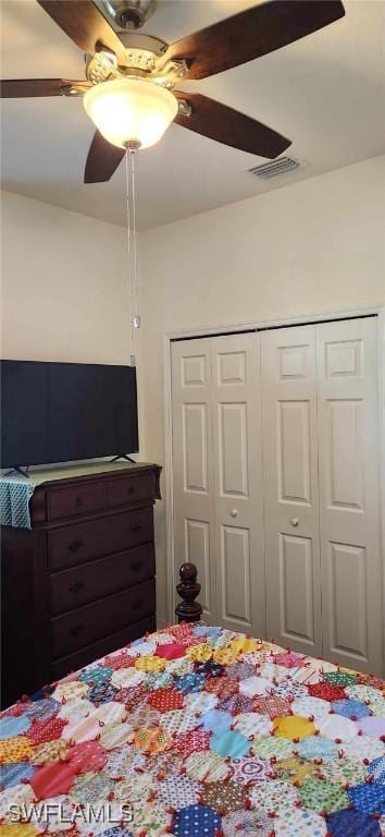 bedroom featuring ceiling fan and a closet