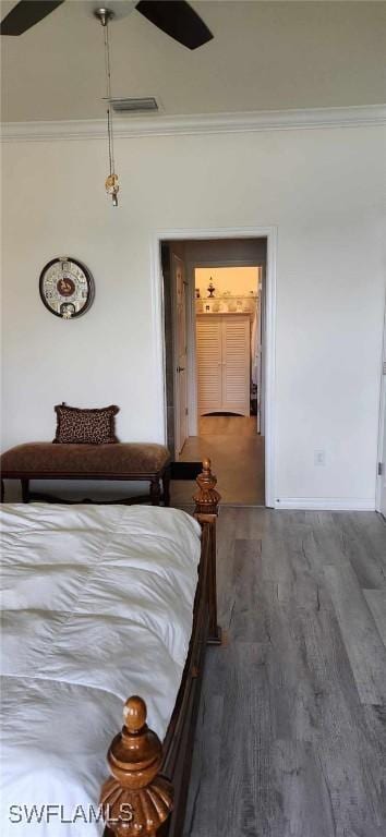 unfurnished bedroom featuring hardwood / wood-style floors, crown molding, and ceiling fan