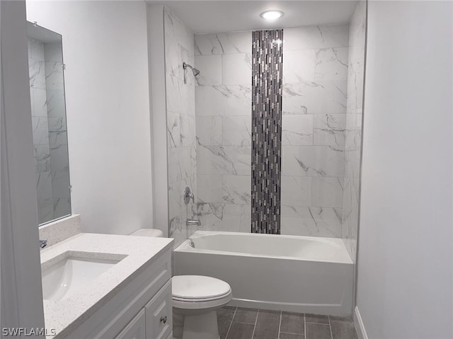 full bathroom featuring tiled shower / bath combo, toilet, tile patterned flooring, and vanity