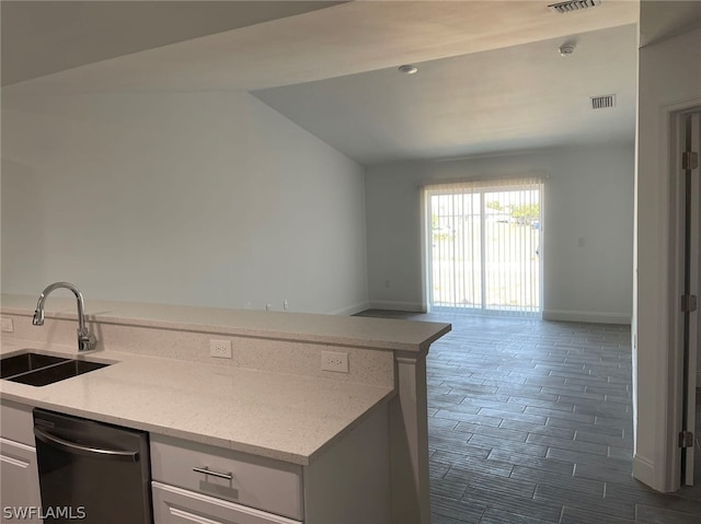 kitchen with sink, dishwasher, white cabinets, and light stone countertops