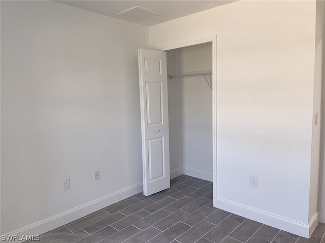 unfurnished bedroom featuring a closet and light tile patterned flooring