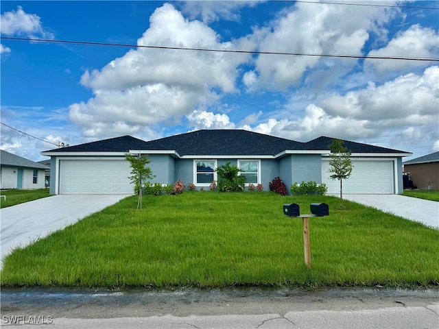 single story home featuring a garage and a front lawn