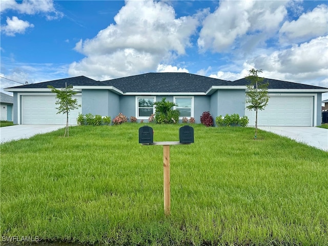 ranch-style house featuring a front yard and a garage