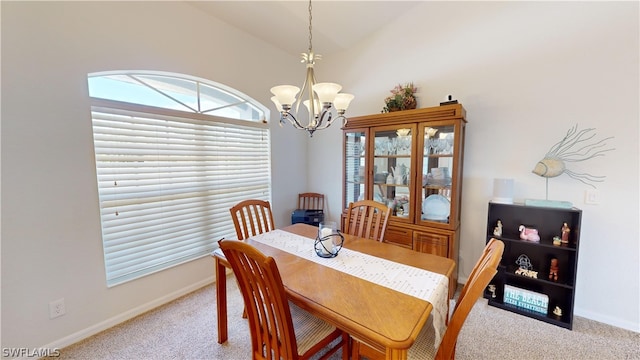 dining space featuring light carpet, lofted ceiling, and a chandelier