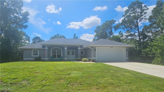 ranch-style home featuring a garage and a front lawn