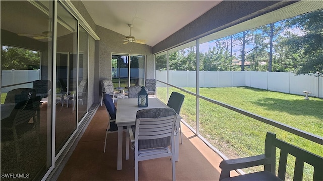 sunroom / solarium with ceiling fan and vaulted ceiling