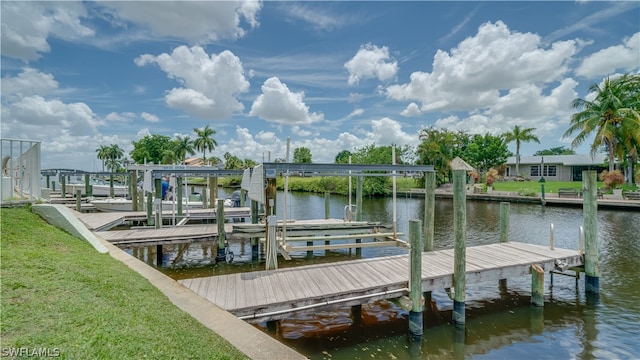 view of dock featuring a lawn and a water view