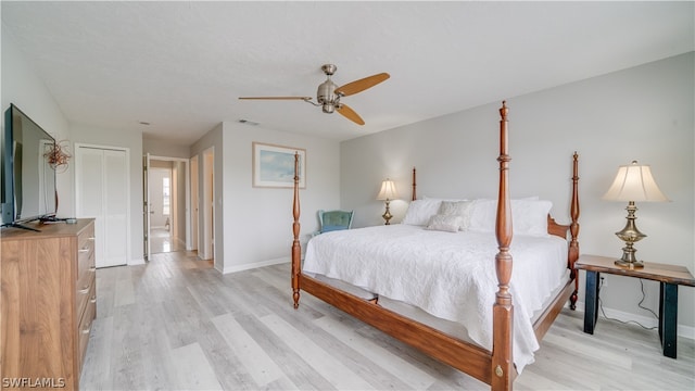 bedroom featuring a closet, light wood-type flooring, and ceiling fan